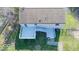 A backyard with a deck and a well-maintained lawn, surrounded by a chain-link fence at 7733 Opelika Ct, Indianapolis, IN 46217