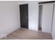 Bedroom featuring wood floors, white walls, a dark door, and a closet at 7733 Opelika Ct, Indianapolis, IN 46217