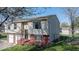 Side view of a two-story home with a brick foundation, and a fenced yard at 7733 Opelika Ct, Indianapolis, IN 46217