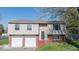 Two-story home featuring an attached two-car garage and brick-accented facade at 7733 Opelika Ct, Indianapolis, IN 46217