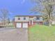 Two-story home with two-car garage, brick accents, and a well-maintained front yard at 7733 Opelika Ct, Indianapolis, IN 46217