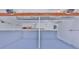 Spacious two car garage with painted floor and overhead storage at 7733 Opelika Ct, Indianapolis, IN 46217