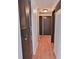 Hallway with wood floors, white walls, and several doors at 7733 Opelika Ct, Indianapolis, IN 46217
