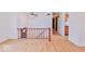 Bright living area featuring wood floors, wood railing and neutral wall paint at 7733 Opelika Ct, Indianapolis, IN 46217