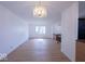 Open living room with wood floors, modern chandelier, and lots of natural light at 7733 Opelika Ct, Indianapolis, IN 46217