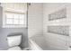 Stylish bathroom features modern bathtub, shower, and decorative tile at 7859 N Chester Ave, Indianapolis, IN 46240