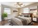 Beautiful primary bedroom with large windows and decorative ceiling fan at 7859 N Chester Ave, Indianapolis, IN 46240