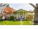 Charming green home with a bright blue front door and lovely landscaping at 7859 N Chester Ave, Indianapolis, IN 46240