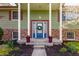 Close up on the front entry, featuring a bright blue door and lovely flowers at 7859 N Chester Ave, Indianapolis, IN 46240