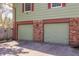 Attached two-car garage with red brick accents and driveway at 7859 N Chester Ave, Indianapolis, IN 46240