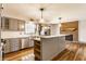 Kitchen with stainless steel appliances, brick fireplace and farmhouse sink at 7859 N Chester Ave, Indianapolis, IN 46240