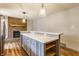 Kitchen island with seating area and brick fireplace in adjacent room at 7859 N Chester Ave, Indianapolis, IN 46240