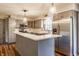Kitchen featuring stainless steel appliances, quartz countertops, and gray cabinets at 7859 N Chester Ave, Indianapolis, IN 46240