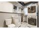Functional laundry room with washer, dryer, vanity, and storage at 7859 N Chester Ave, Indianapolis, IN 46240