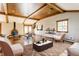 Bright living room with wood-beam ceiling, modern furniture, and fireplace at 7859 N Chester Ave, Indianapolis, IN 46240