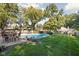 A beautiful in-ground pool surrounded by a green lawn and mature trees for privacy at 7859 N Chester Ave, Indianapolis, IN 46240