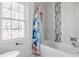 Bright and clean bathroom with stylish shower curtain and marble tile at 8020 N Meridian N St, Indianapolis, IN 46260