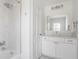 Bright and clean bathroom with marble tile and white vanity and cabinets at 8020 N Meridian N St, Indianapolis, IN 46260