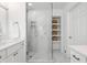 Modern bathroom with glass shower, marble tile, and built-in shelving for storage at 8020 N Meridian N St, Indianapolis, IN 46260