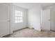Clean bedroom with plush carpet, a large window, and a closet at 8020 N Meridian N St, Indianapolis, IN 46260