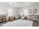 Bright Bedroom with two windows, a crib, a changing table and a neutral rug on dark wood floors at 8020 N Meridian N St, Indianapolis, IN 46260
