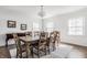 Dining room with a large table with seating for 10, hardwood floors, and a crystal chandelier at 8020 N Meridian N St, Indianapolis, IN 46260