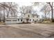 A stunning view of the home's exterior with a three-car garage and stone patio at 8020 N Meridian N St, Indianapolis, IN 46260