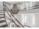 Elegant foyer featuring a wrought iron staircase and a stunning chandelier at 8020 N Meridian N St, Indianapolis, IN 46260