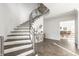 Bright foyer with wood floors, a winding staircase with metal railing, and an elegant chandelier at 8020 N Meridian N St, Indianapolis, IN 46260