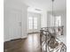 Open hallway with dark hardwood floors, elegant chandelier, and natural light at 8020 N Meridian N St, Indianapolis, IN 46260