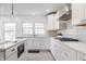 Contemporary kitchen with white cabinets, quartz countertops and stainless steel appliances at 8020 N Meridian N St, Indianapolis, IN 46260
