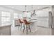 Modern kitchen with stainless steel appliances, white cabinets, island with chairs and pendant lights at 8020 N Meridian N St, Indianapolis, IN 46260