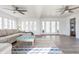 Sunroom featuring ceiling fans, neutral decor, and view to backyard at 8020 N Meridian N St, Indianapolis, IN 46260