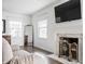 Bright living room featuring a fireplace, hardwood floors, and lots of natural light at 8020 N Meridian N St, Indianapolis, IN 46260
