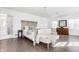 Spacious main bedroom showcasing a seating area, hardwood floors, and bright lighting at 8020 N Meridian N St, Indianapolis, IN 46260