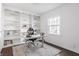 Well-lit home office with built-in bookshelves and dark wood floors at 8020 N Meridian N St, Indianapolis, IN 46260