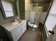 Bathroom with a white vanity and sink, a walk-in shower with glass doors, and a mirror at 8054 Harvest Ln, Indianapolis, IN 46256