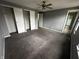 Spacious bedroom with a ceiling fan, carpet flooring, and a walk-in closet at 8054 Harvest Ln, Indianapolis, IN 46256