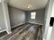 A cozy bedroom featuring gray walls and wood-look flooring, offering a serene and comfortable retreat at 8054 Harvest Ln, Indianapolis, IN 46256