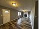 Inviting living room with a white brick fireplace, modern floors, and ample natural light at 8054 Harvest Ln, Indianapolis, IN 46256