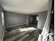 Bright living room with gray walls and modern wood-look floors, perfect for relaxing or entertaining guests at 8054 Harvest Ln, Indianapolis, IN 46256