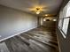 Bright, open living room with modern floors, ceiling fan, and natural light, perfect for comfortable living at 8054 Harvest Ln, Indianapolis, IN 46256