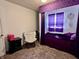 Charming bedroom with unique purple accents, soft textures and natural light from the window at 810 Fabyan Rd, Indianapolis, IN 46217