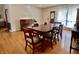 Dining room with wood floors, large table, and a vintage piano at 810 Fabyan Rd, Indianapolis, IN 46217