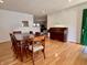 Dining room with wood floors and vintage piano next to the dining table at 810 Fabyan Rd, Indianapolis, IN 46217