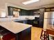 Modern kitchen with black cabinets, stainless steel appliances, and breakfast bar at 810 Fabyan Rd, Indianapolis, IN 46217