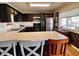 Kitchen with black cabinets, stainless steel appliances and peninsula countertop at 810 Fabyan Rd, Indianapolis, IN 46217