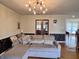 Comfortable living room with neutral tones, modern light fixture, and charming decorative pillows at 810 Fabyan Rd, Indianapolis, IN 46217