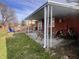 Relaxing covered patio with seating, adjacent to a well-maintained yard and brick home exterior at 810 Fabyan Rd, Indianapolis, IN 46217