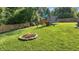 Backyard featuring a playset, firepit, and fenced yard at 859 E Bunkerhill Rd, Mooresville, IN 46158